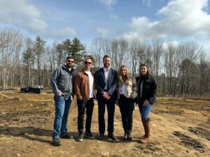 Group of Construction team and Partners Bank team standing on job site