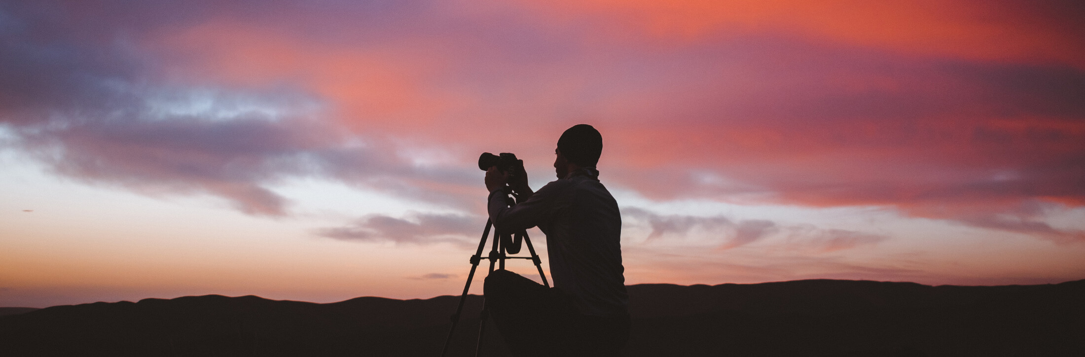 Photographer with sunset clouds