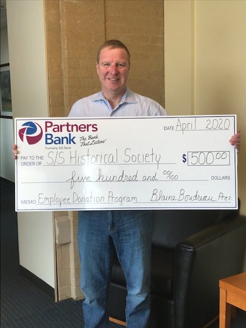 Chris MacDonnell with $500 check for Sanford/Springval Historical Society