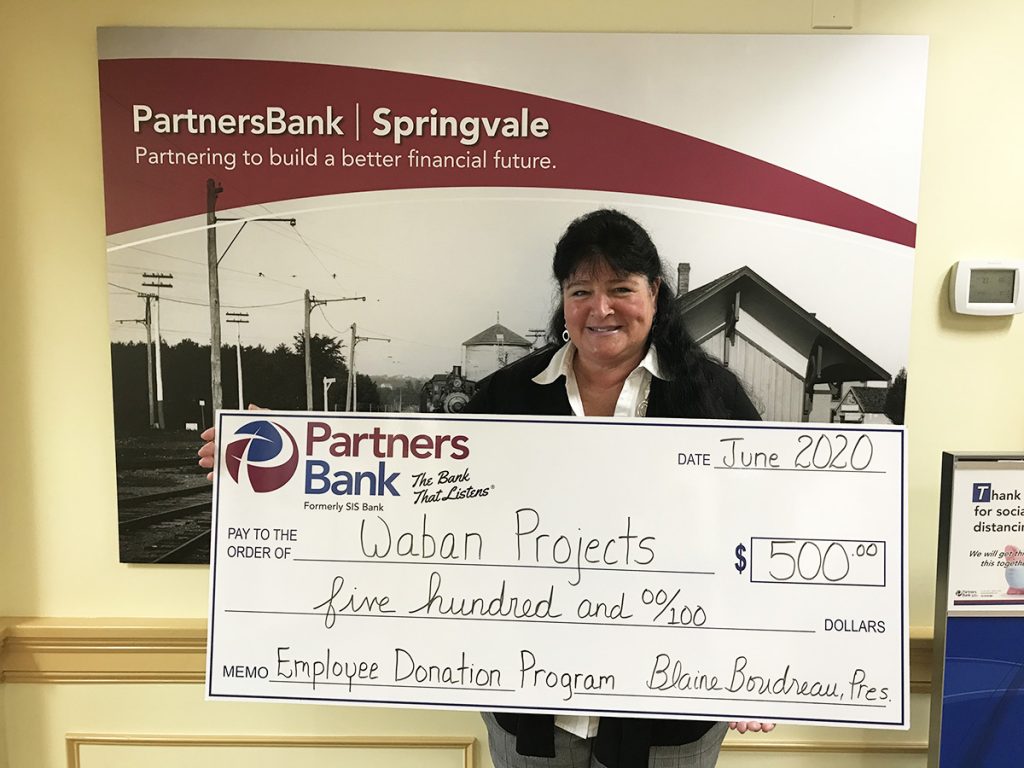Partners Bank's Grace Hutchins with $500 check made out to Waban for Employee Donation Program
