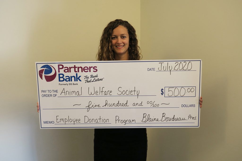 Partners Bank's, Mandy Elliston with $500 check donation for Kennebunk Animal Welfare Society through Bank's Employee Donation Program.