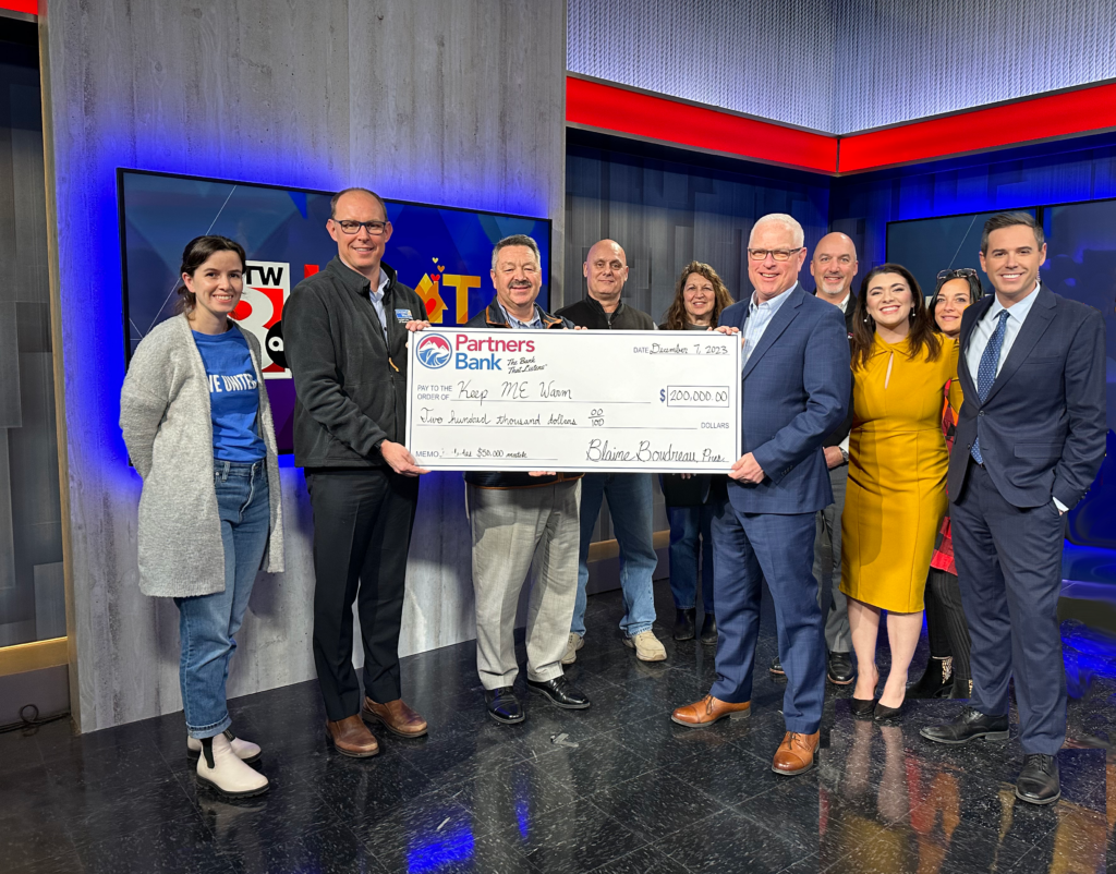 Partners Bank, WMTW and United Way team members holding a check for the Heating Assistance Fund in Maine & New Hampshire