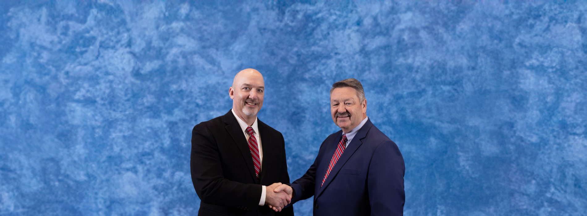 Partners Bank team members shaking hands with blue background