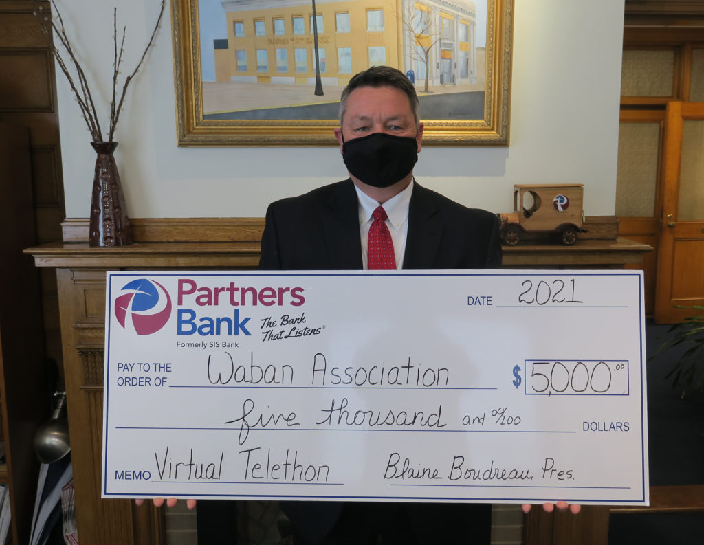 Partners Bank President and CEO, Blaine Boudreau with $5,000 check for Waban.
