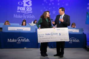 Partners Bank presenting check to Make a Wish Foundation during telethon