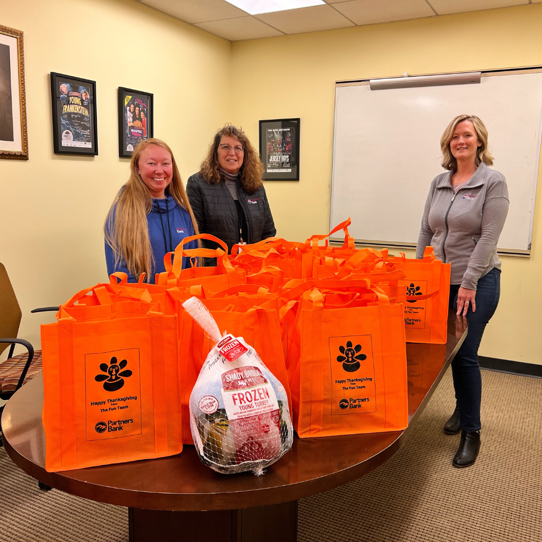 Partners Bank employees donating turkeys to YCSP