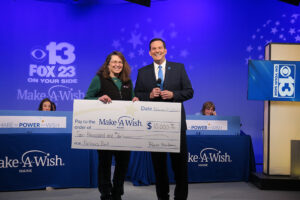 Partners Bank presenting check to Make a Wish Foundation during telethon